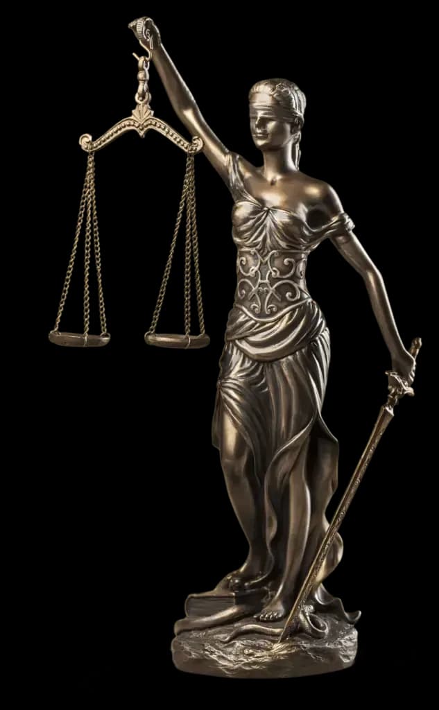 A statuette of Lady Justice with scales, a gavel and an open law book